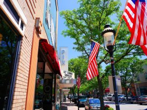 Waukesha, USA - June 26, 2014: Main Street in Historic Downtown Waukesha. The streets are decorated with American Flags around the 4th of July.