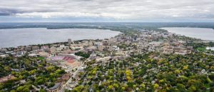 Dramatic aerial shot of Madison, Wisconsin that shows the square and isthmus from the southeast. Lake Mendota on the left and Lake Monona on the right.