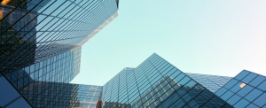 City skyscrapers reaching up into a blue sky.